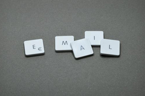 5 small letter tiles spelling out email in capital letters