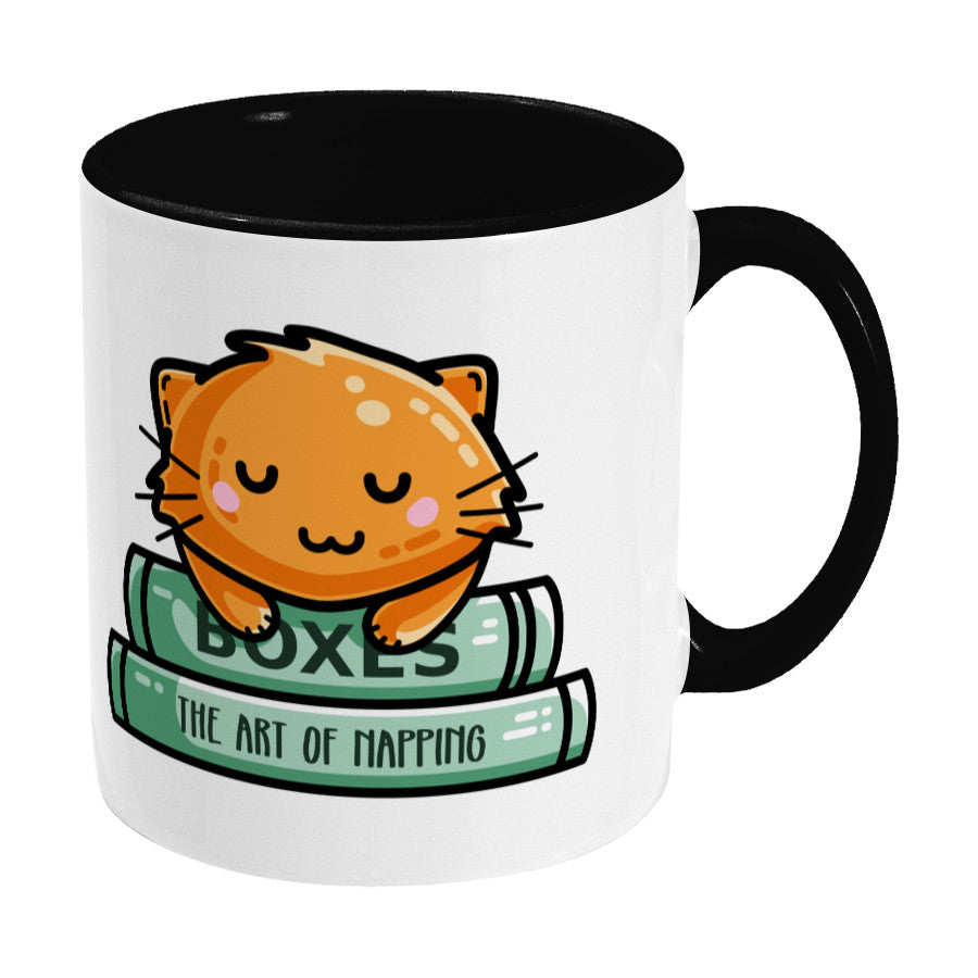 Cute ginger cat asleep on books design on a two toned black and white ceramic mug, showing RHS