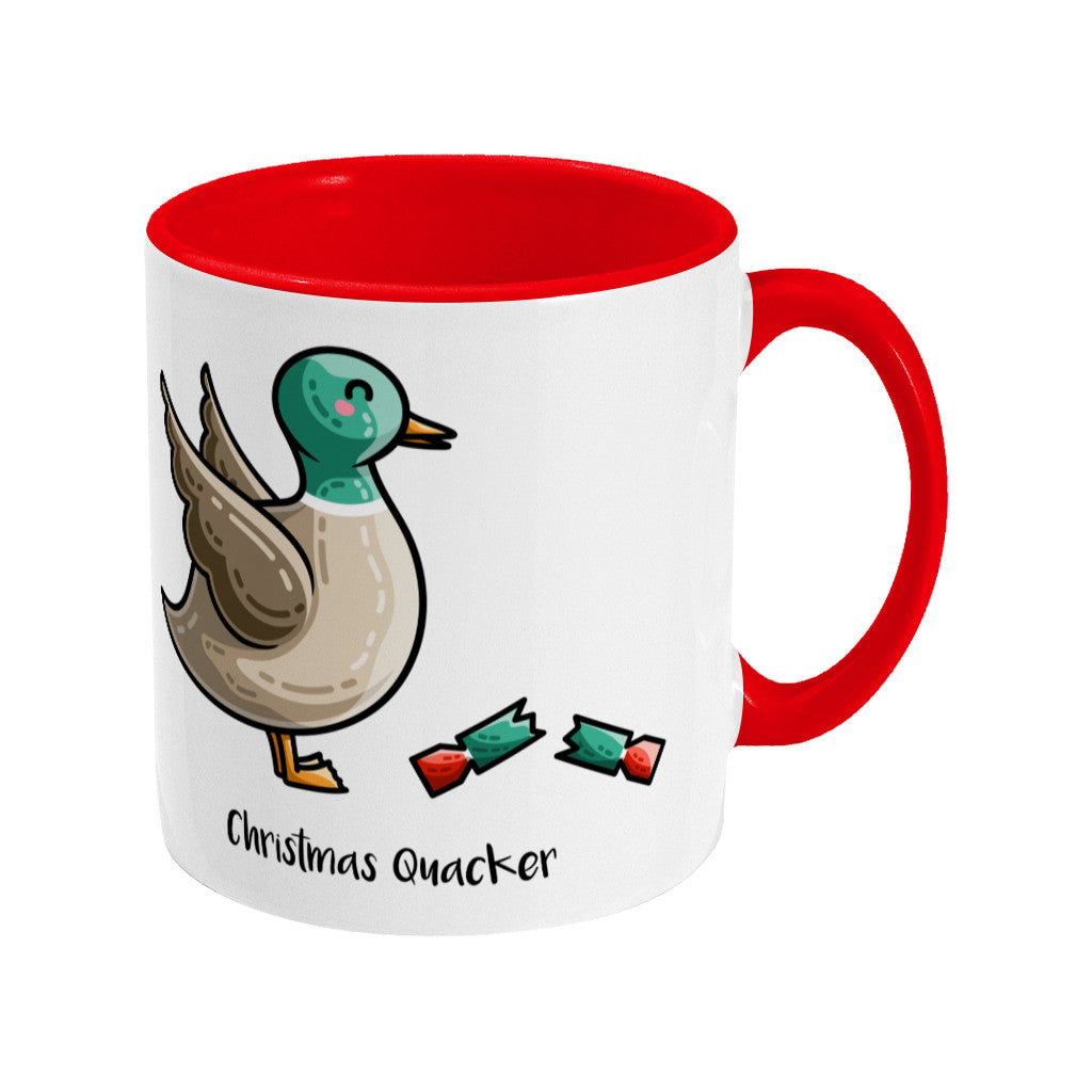 A two toned white and red ceramic mug with the handle to the right showing a design of a mallard duck with a red and green Christmas cracker and the words Christmas Quacker written in black beneath