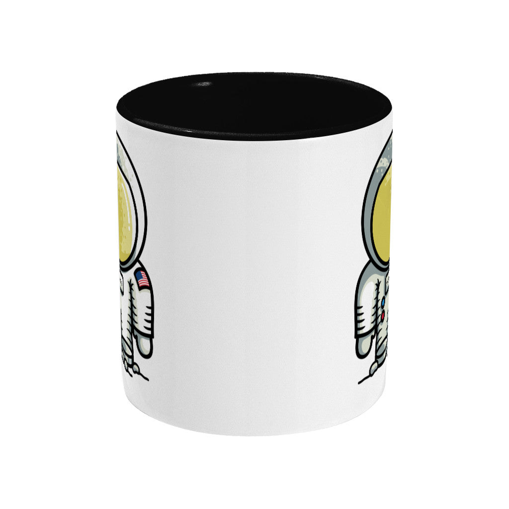 A two toned black and white ceramic mug, showing a side view with the handle hidden behind, with the edge of a design showing to the left and right sides of the mug.