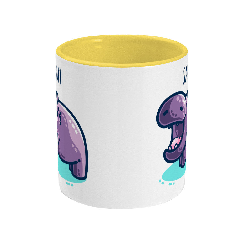 A white ceramic mug with a yellow inside. Seen side on with the handle not visible around the other side. A small part of the mug design can be seen on either edge of the mug as the design is duplicated either side of the handle.
