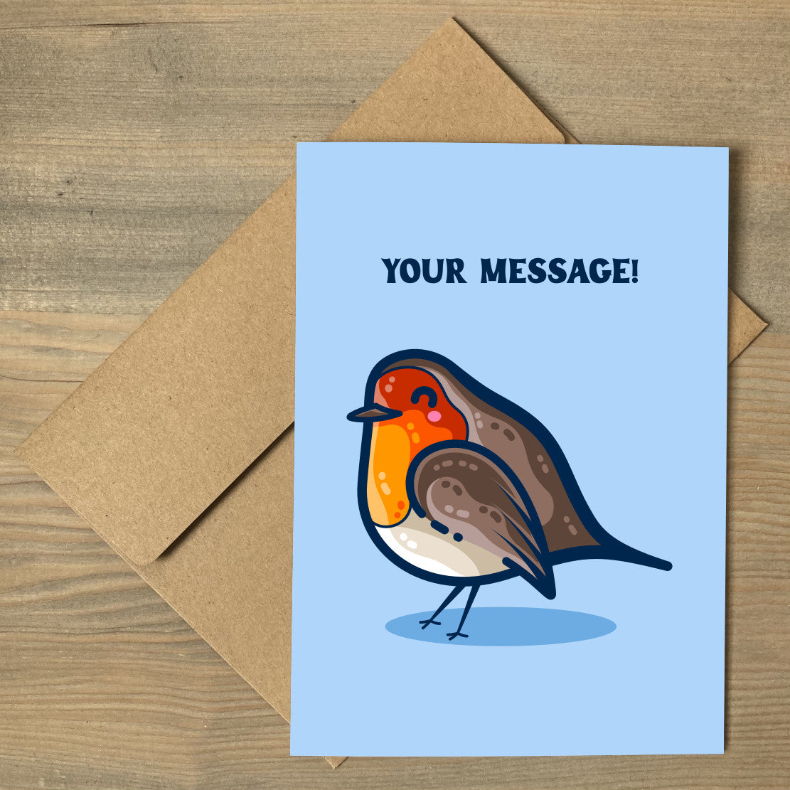 A blue greeting card lying flat on a brown envelope, with a design of a kawaii cute robin bird facing to the left and your personalised message above