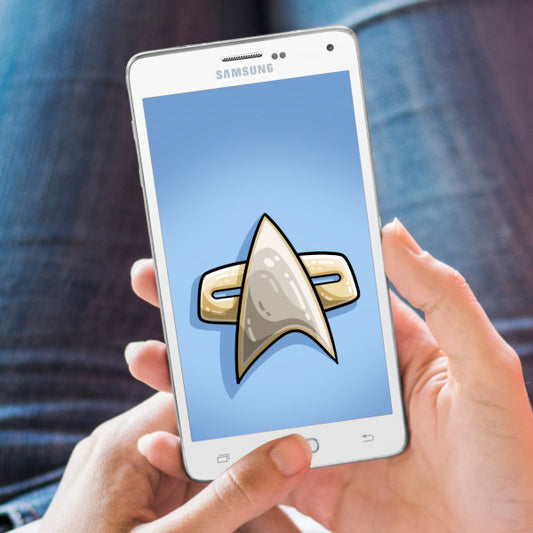 A hand holding a mobile phone with a Star Trek Voyager communicator badge wallpaper