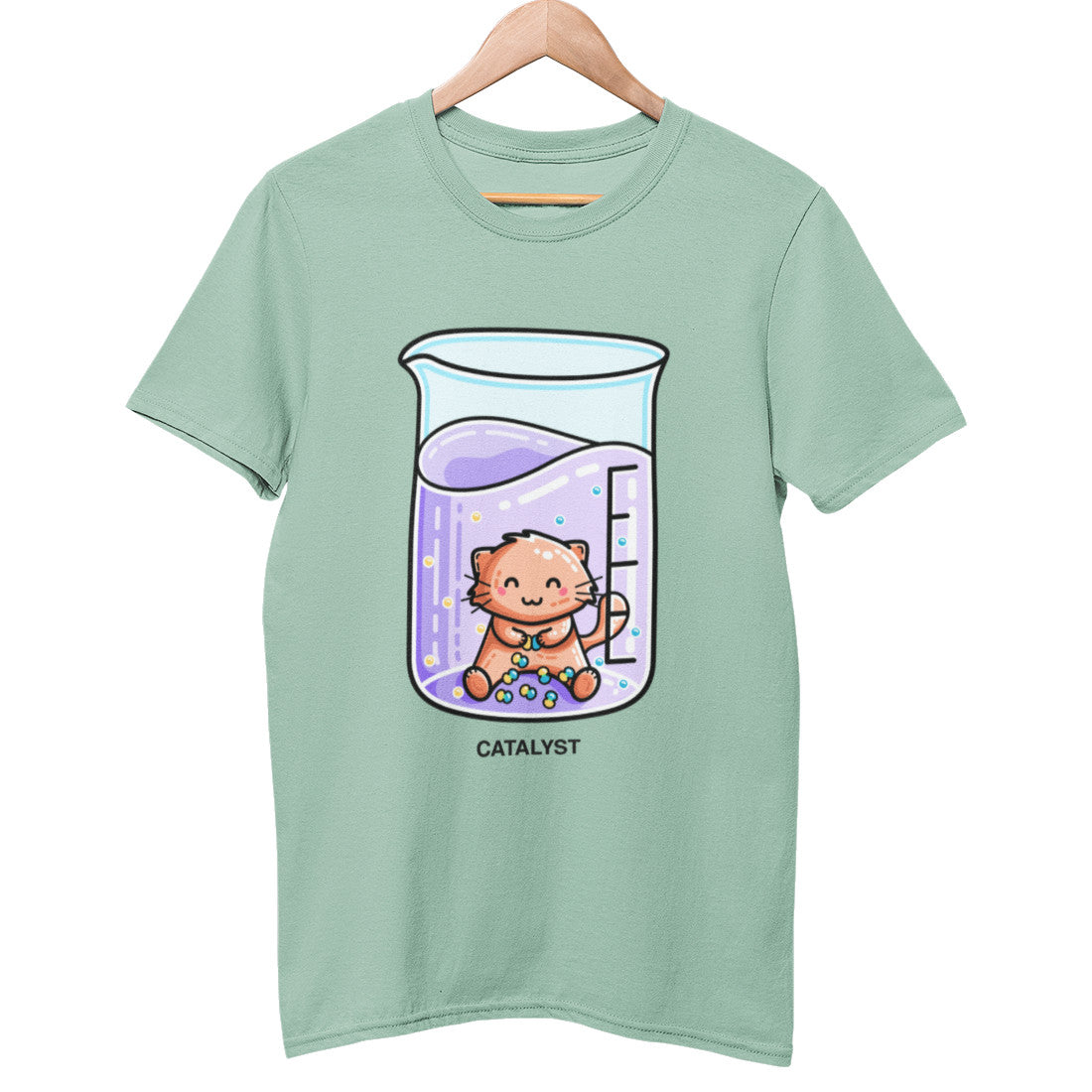 A pale aloe green coloured unisex crewneck t-shirt on a hanger with a design on its chest of a cute ginger cat sitting in a chemistry beaker of purple liquid joining atoms or yellow and green together