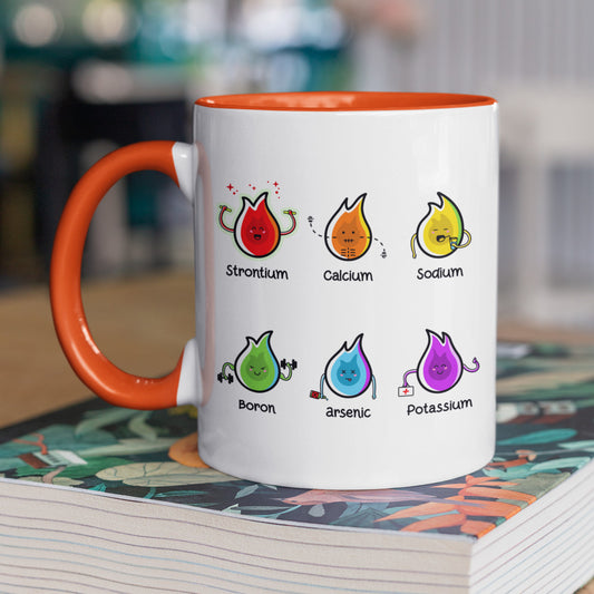 A two toned white and orange ceramic mug, handle on left, with a design of 6 different coloured flames of different elements and their characteristics with the name of the element beneath each flame.