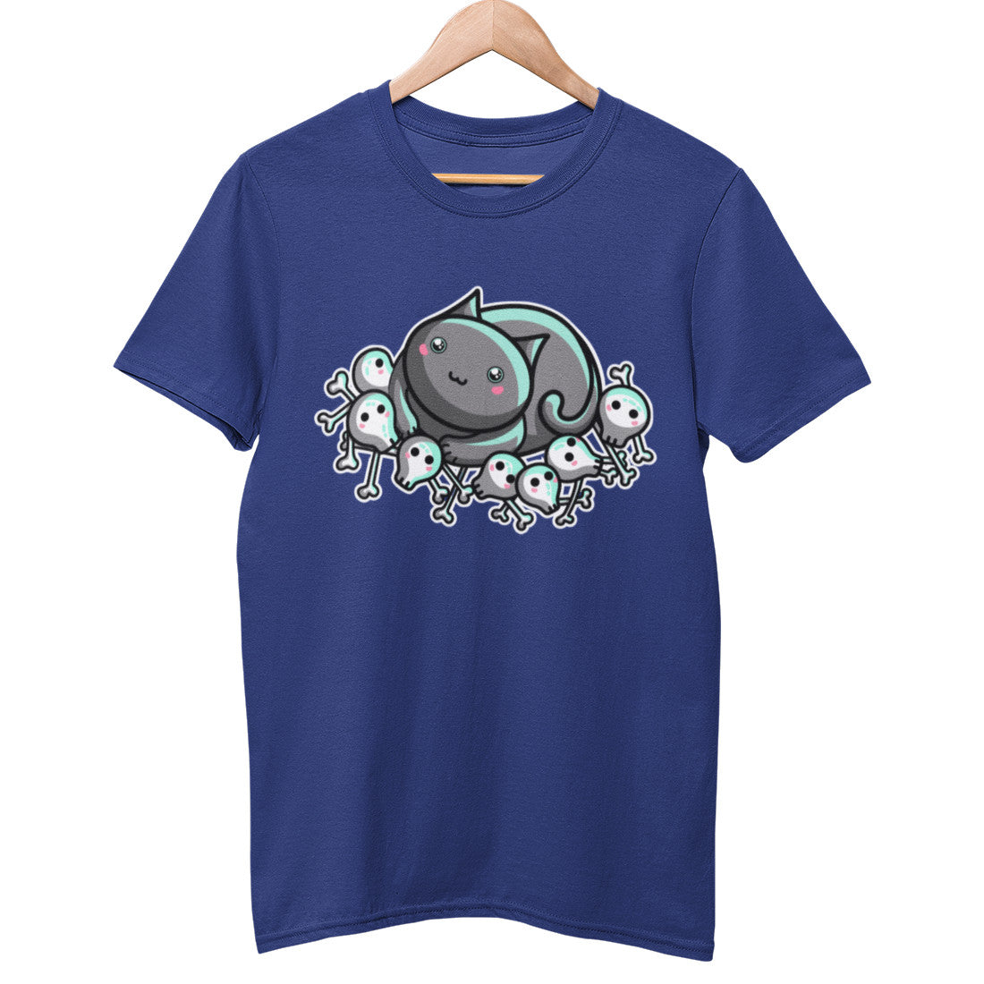 A blue colour unisex crewneck t-shirt on a hanger with a design on its chest of a kawaii cute cat contendedly, looking innocently up, lying on a pile of skulls and bones