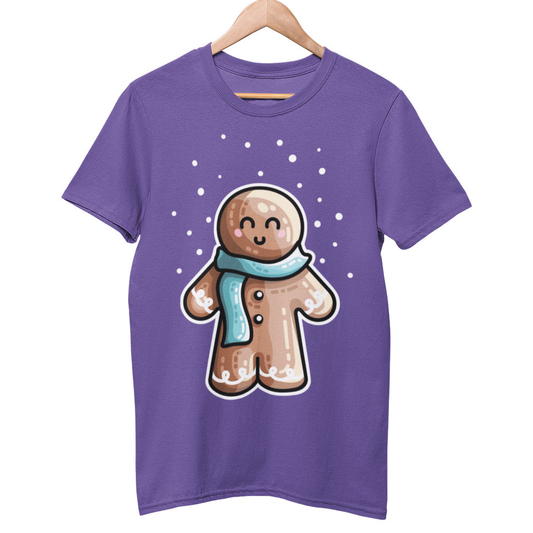 A purple unisex crewneck t-shirt on a hanger with a design of a kawaii cute gingerbread person standing in the snow and wearing a blue scarf