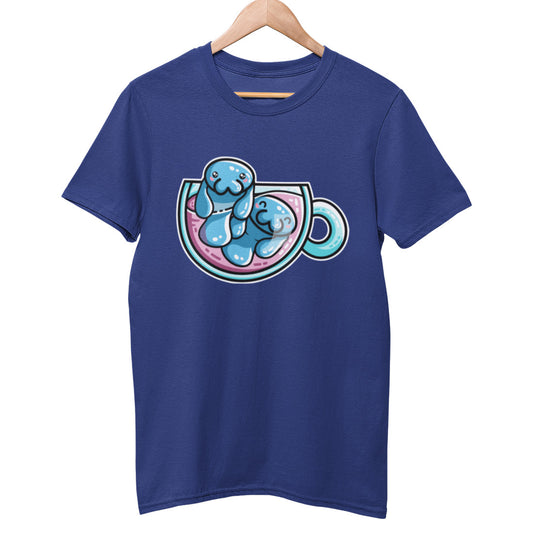 A blue colour unisex crewneck t-shirt on a wooden hanger with a design on its chest of two kawaii cute blue manatee swimming in a glass teacup of purple liquid