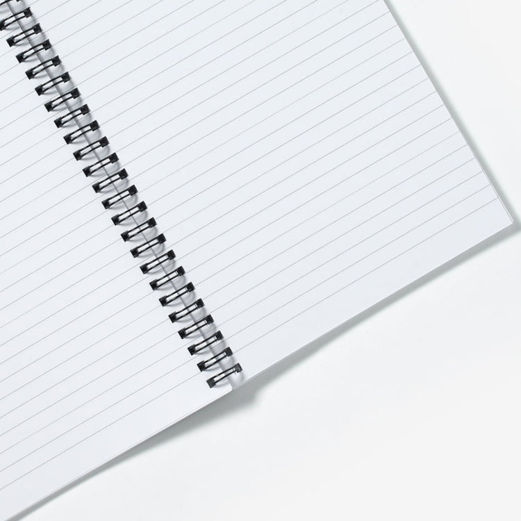 A close up view of the inner notebook pages, showing lined paper.