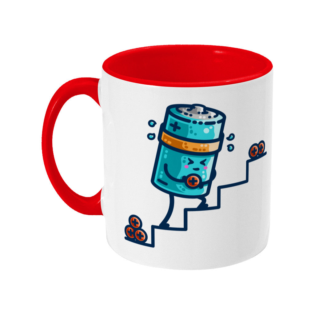 A two-toned red and white ceramic mug with the handle to the left and a design of a kawaii cute blue cylindrical battery wearing an orange sweatband, with a facial expression of effort, moving positive charge up steps.