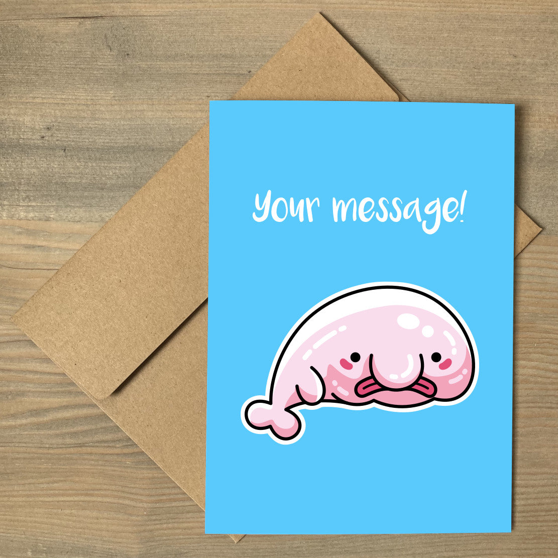 A brown envelope beneath a blue greeting card that features a kawaii cute blobfish with a personalised message above.