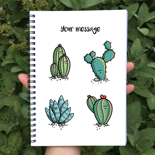 Closed notebook showing white front cover with personalisation and four cute cactus plants
