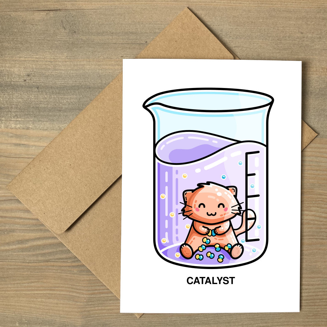 A brown envelope beneath a white greeting card that features a cute cat joining atoms in a chemistry beaker of liquid with a personalised message above.