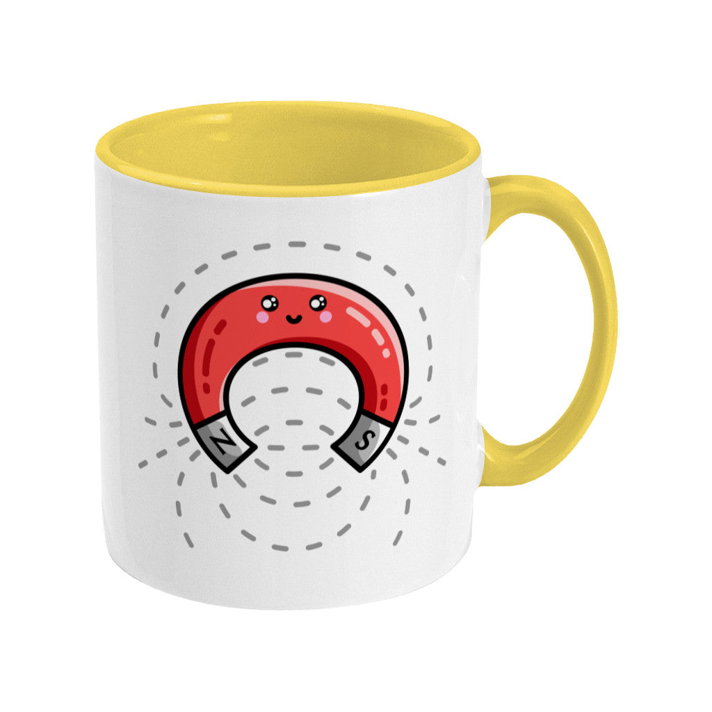 A white and yellow two toned ceramic mug, with the handle to the right, and a design of a cute red magnet with magnetic field lines.