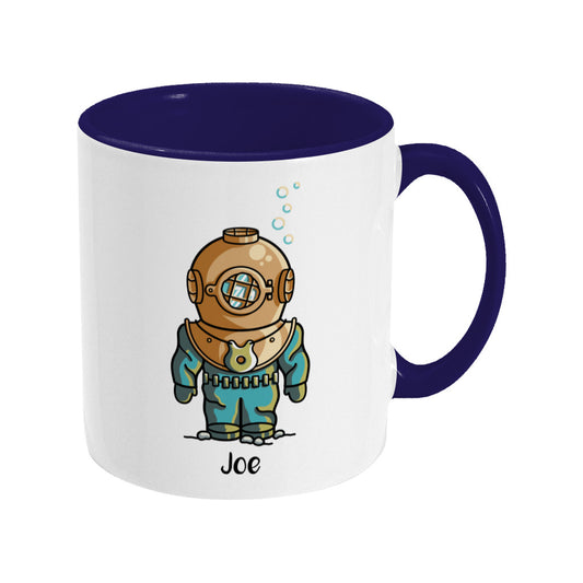 A two toned navy and white ceramic mug, handle to the right, with a personalised design of a cute vintage deep sea diver.