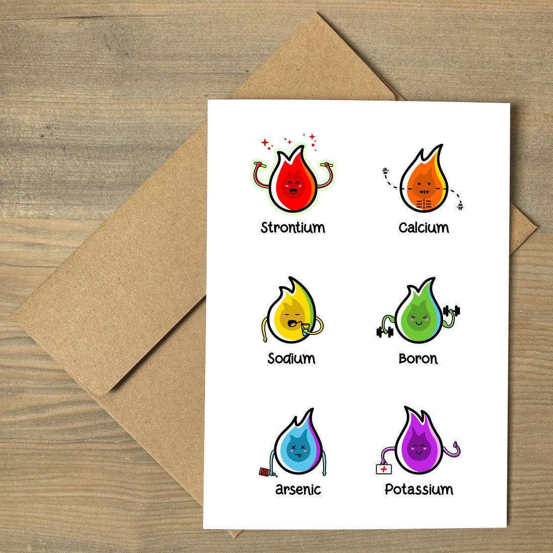 A brown envelope beneath a white greeting card that features a six cute coloured chemistry element flames.
