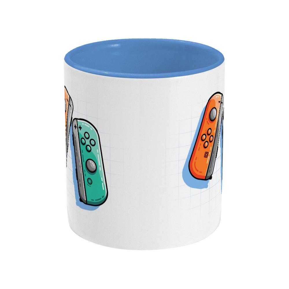 An orange and a turquoise game controller design on a two toned navy and white ceramic mug, side view