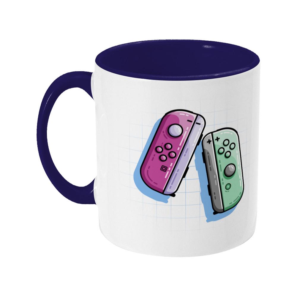 A pink and a green game controller design on a two toned navy and white ceramic mug, showing LHS