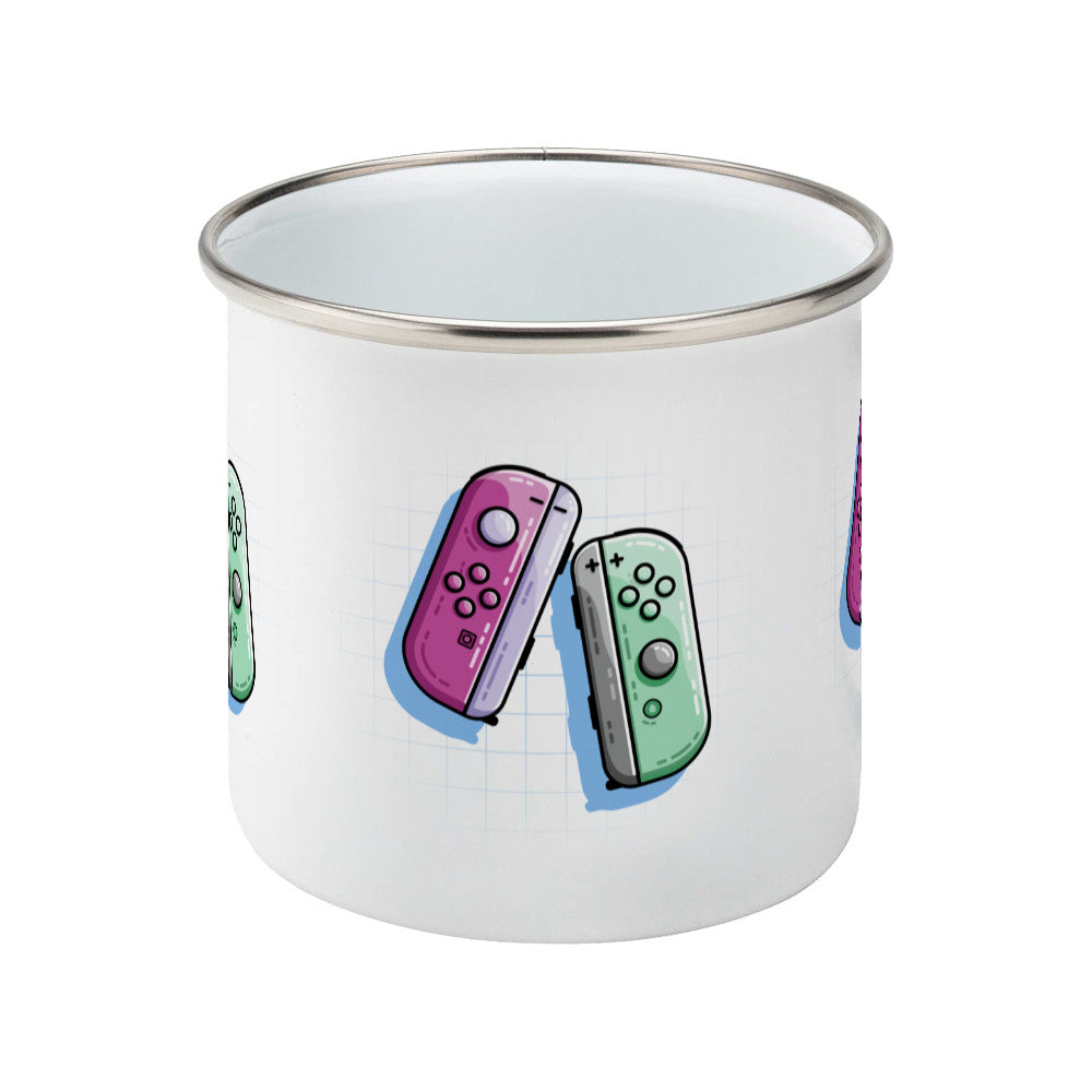 A pink and a green game controller design on a silver rimmed enamel mug, side view
