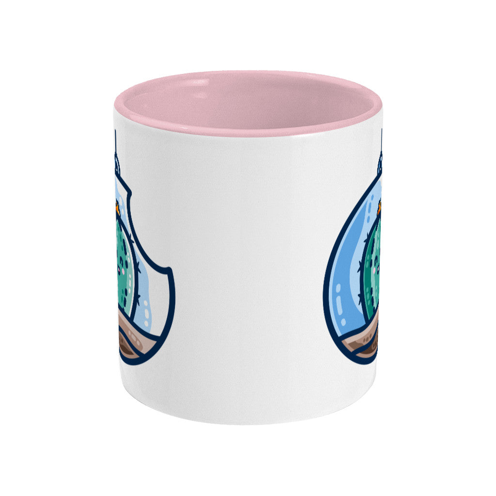 A two toned white and pale pink ceramic mug seen side on with the handle hidden behind and a portion of the design visible at each edge of the mug.