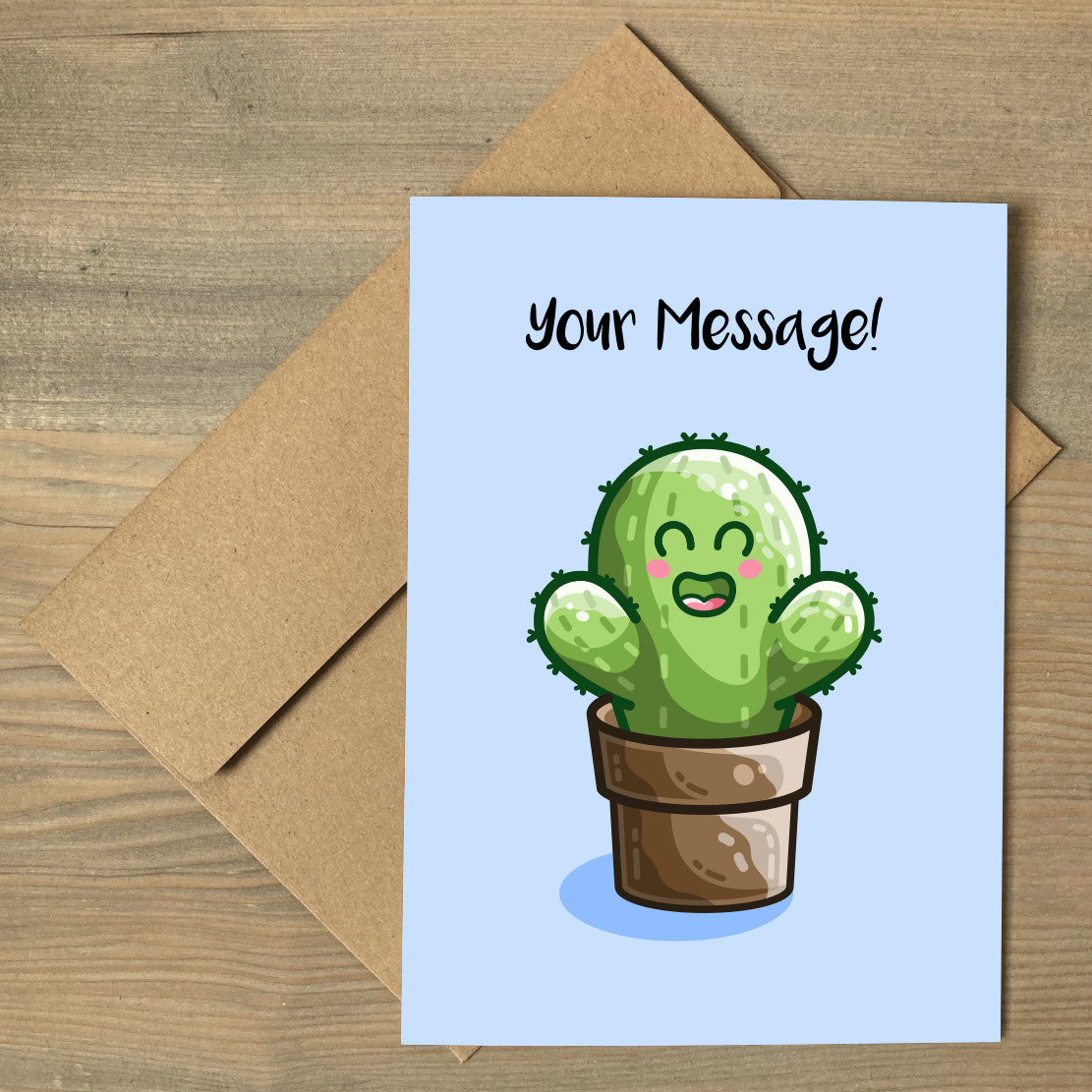 A brown envelope beneath a blue greeting card that features a kawaii cute green cactus in a brown plant pot with a personalised message above.