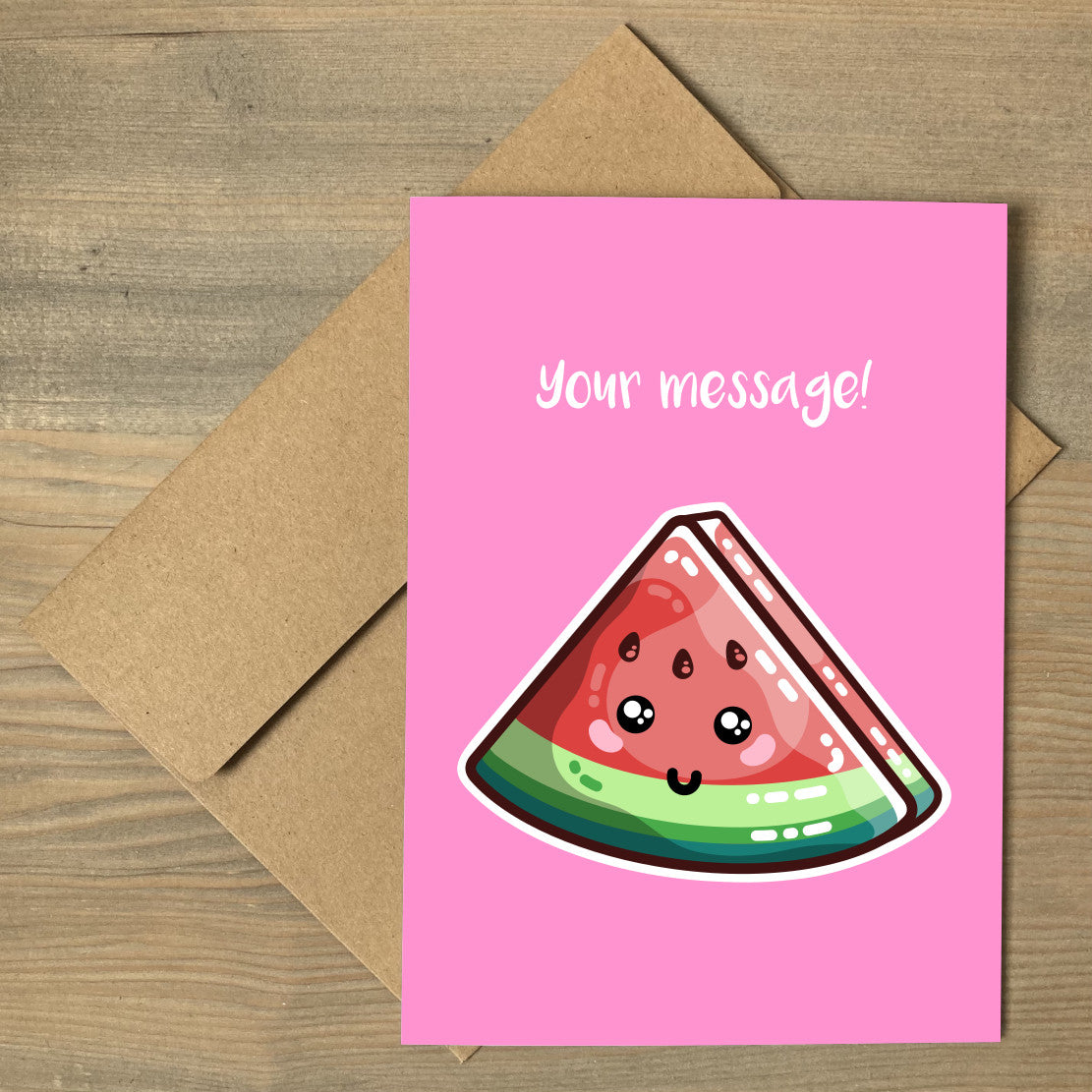 A pink greeting card lying flat on a brown envelope, with a design of a kawaii cute slice of watermelon and personalised with a message above