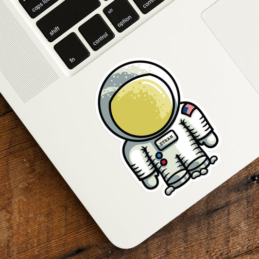 Cute astronaut space suit vinyl sticker on a laptop computer keyboard