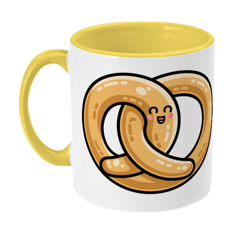 Kawaii cute pretzel design on a two toned yellow and white ceramic mug, showing LHS