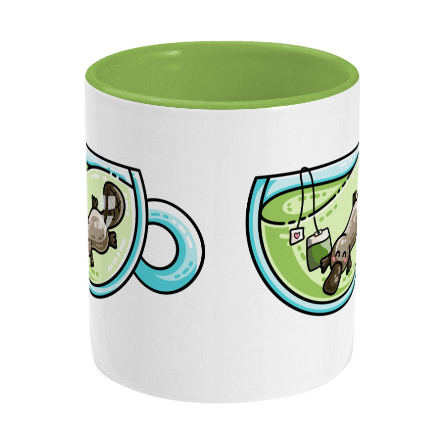 Cute platypus swimming in a glass teacup of green tea design on a two toned green and white ceramic mug, side view