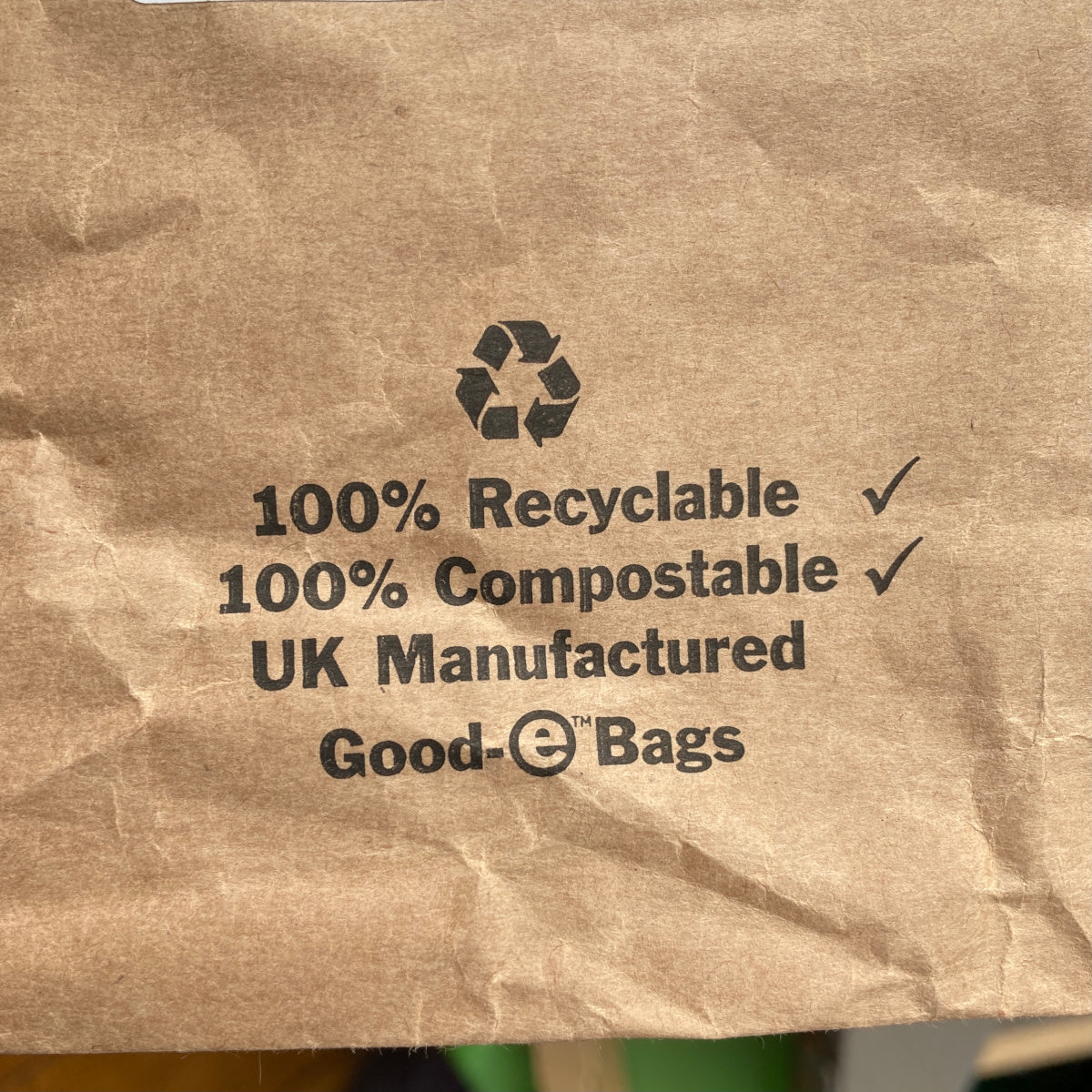 Close up of printed information on paper mailing bag, 100 percent recyclable, 100 percent compostable, UK manufactured
