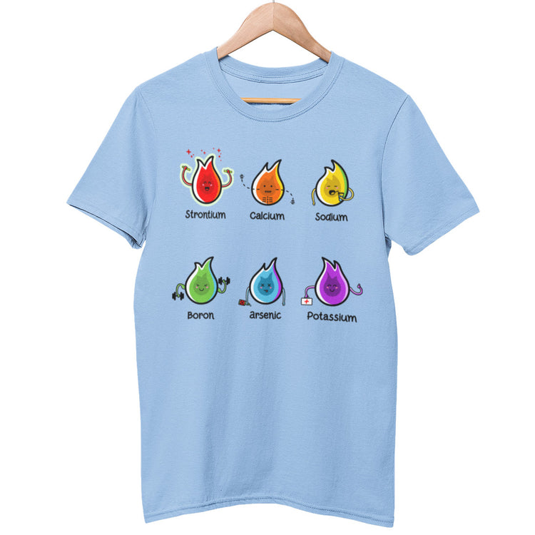 A pale blue unisex crewneck t-shirt on a wooden hanger with a design on the chest of 6 different coloured flames of different elements and their characteristics with the name of the element beneath each flame for example strontium