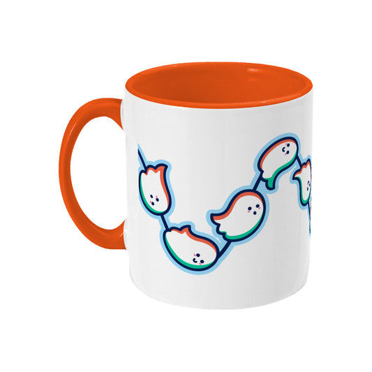 A white mug with an orange handle and inside, with a design of a wavy line of cute ghosts flying from left to right around the mug. Handle on left.